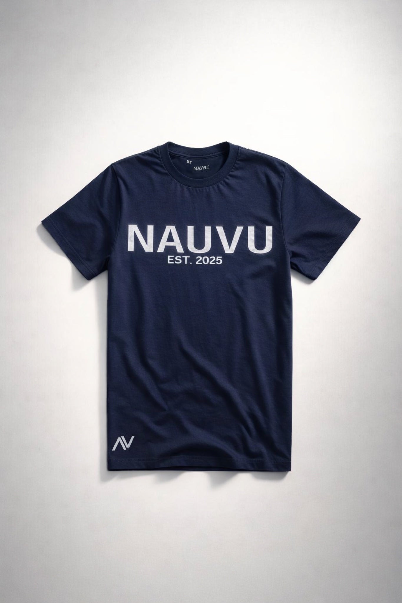Navy blue t-shirt with 'NAUVU EST. 2025' text on a light gray background