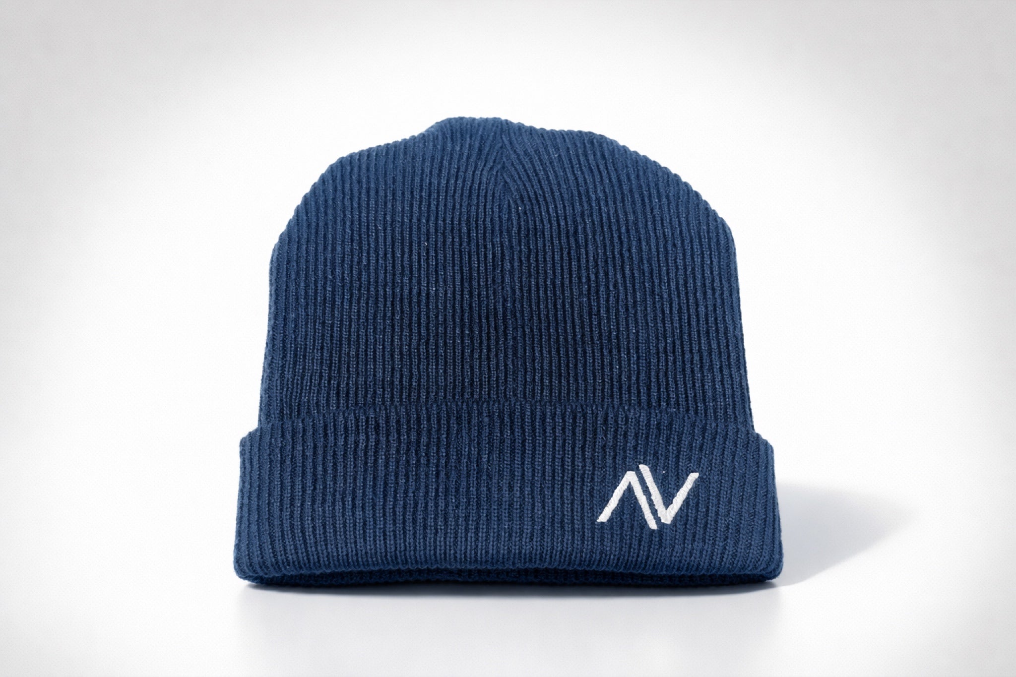 Unisex ribbed knit beanie with embroidered logo styled in casual streetwear outfit