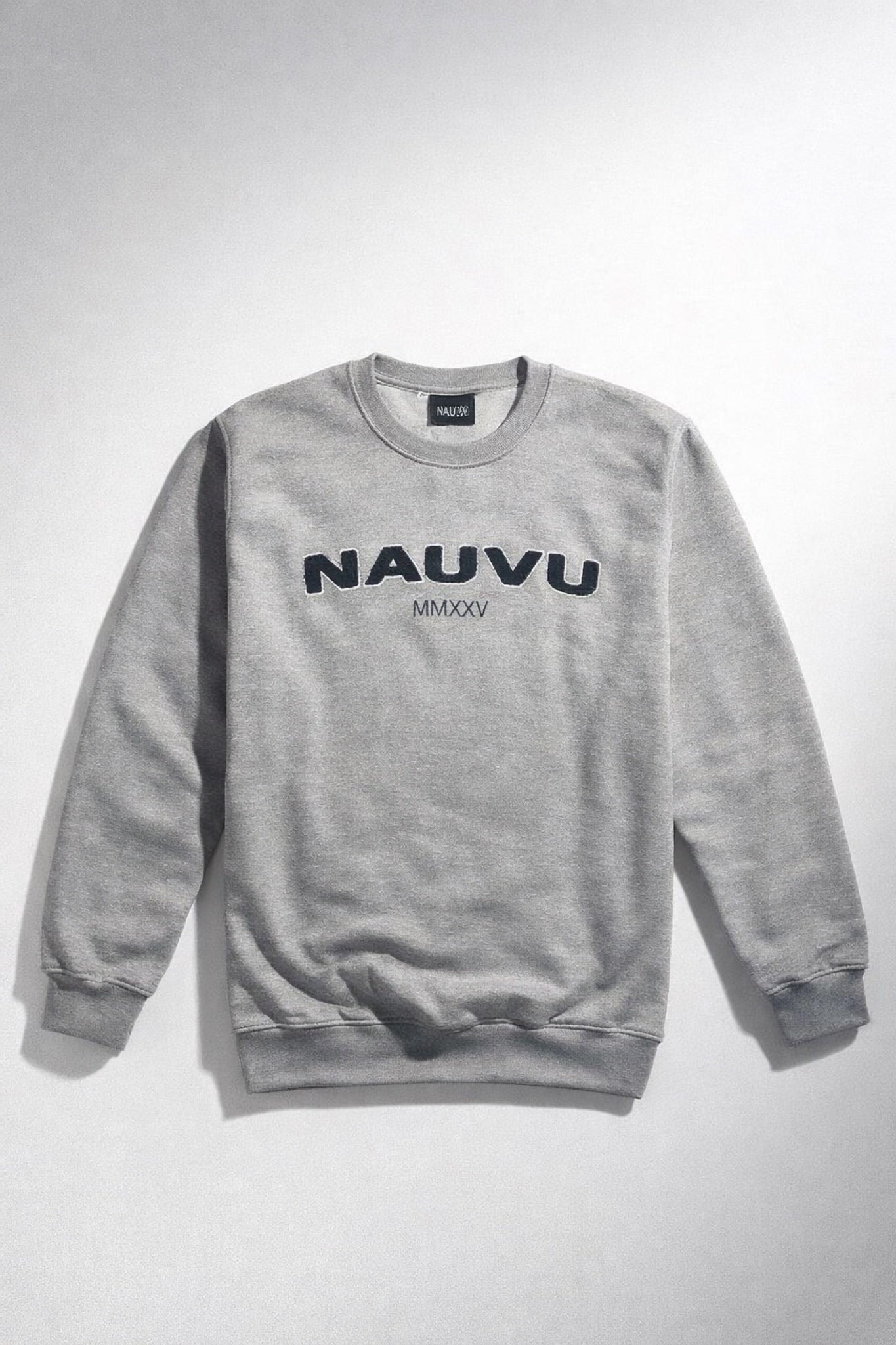 Close-up of embroidered sleeve logo on women’s chenille varsity sweatshirt